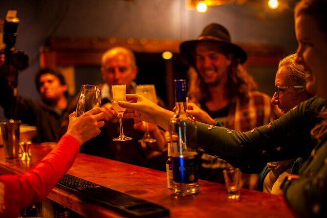 Pisco Sour Secrets: Hands-On Mixology in Historic Cusco - Casa Intrepid: shaking cocktails against Inca walls
